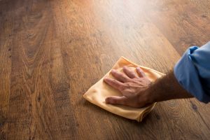 finishing up a hardwood floor cleaning with a quick wipe