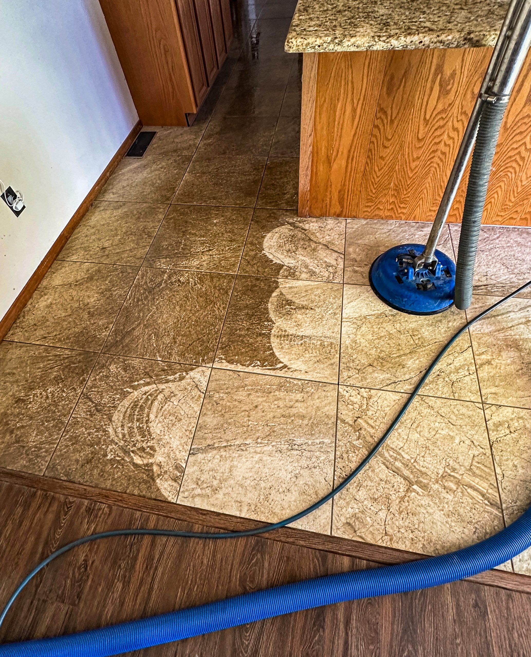 Tile cleaning in process. Half the floor is clean while the other half is unclean.